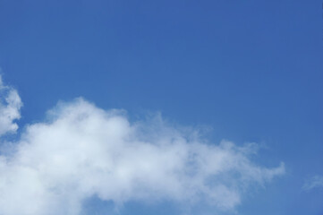 Bright blue sky background in sunny day with white cloud below . Nature ,  beautiful sky landscape.