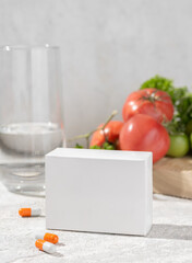 Mockup of an empty white box for product packaging with medicines or vitamins with pills. In the interior. Place for logo and text