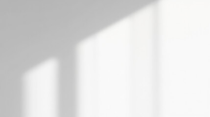 Soft sunlight creates artistic contrast with shadows from window shapes on white wall surface, illustrating symmetry and refined elegance in serene design