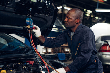 Auto mechanic are checking and repair maintenance auto engine is problems at car repair shop.