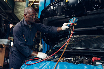 Auto mechanic are checking and repair maintenance auto engine is problems at car repair shop.