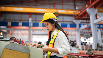 Industrial woman engineer wear uniform checking system machine at factory.