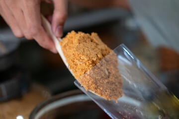 A close-up shot of Abon Ayam, a shredded chicken floss, showcasing its fibrous texture and savory,...