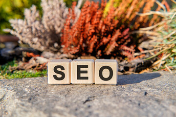 SEO text on cubes standing on a stone on a natural background