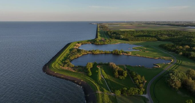 Flood barrrier, dike, water and nature, The Netherlands. waterline. artificial man made water works, The Netherlands.