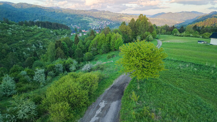 Aerial view of fields and landscape in the Pieniny Mountains in Poland during a May sunset,...