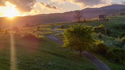 Aerial view of fields and landscape in the Pieniny Mountains in Poland during a May sunset,...