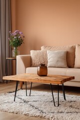 Interior of living room with wooden coffee table and beige sofa in a cozy home setting, eye level view, indoor