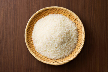 Serving raw Japanese rice in a bamboo sieve
