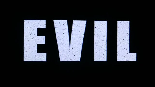 Evil in text titles, with video noise and static. Original elements manipulated on damaged analog tape, captured with a 4K camera from a VHS video tape VCR. 