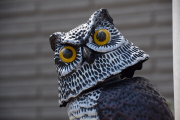 Sculpture of a owl with yellow eyes, close-up