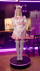Anime cosplay girl pink maid real life figurine rotate on platform in kitchen