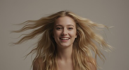 Fototapeta premium Radiant Woman with Blonde Frizzy Hair Smiling on Light Gray Background for Beauty or Cosmetic Theme Close Up Portrait