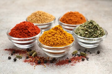 Different aromatic spices on light grey table, closeup
