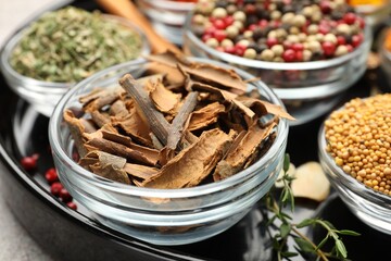 Different aromatic spices on light grey table, closeup