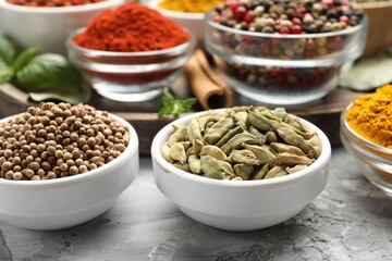 Different aromatic spices on grey table, closeup