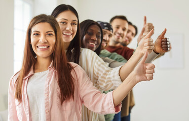 Thumb up happy friends gesture of approval, encouragement, young people diverse group raising thumb showing agreement, smiling people expressing positivity, idea approval, job, like achievement