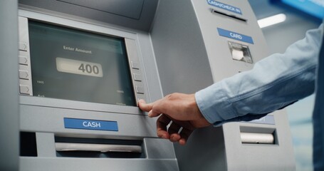 ATM Machine in Airport Terminal: Man Inserting Card, Pressing Buttons on ATM Keypad, Entering PIN...