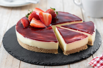 Cheesecake with strawberries on wooden table