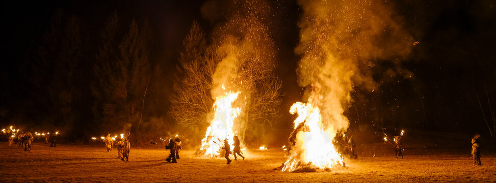 Night scene of a Krampus parade with large bonfires and people in costume carrying torches. Krampus and St Nicholas, 5 December in Tarvisio, Friuli Venezia Giulia, Julian Alps, Italy.