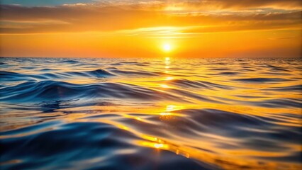 Obraz premium Soft golden hues fade into undulating waves on a serene ocean surface , water texture