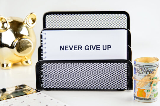 Naklejki Business development challenge concept and effort success idea. Never give up written on a blank sheet of notepad, a close-up view from the front