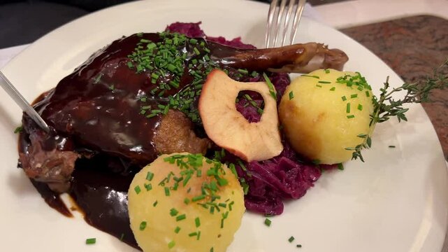 Roasted turkey or goose with potato dumplings and red cabbage, traditional holiday meal
