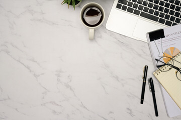 Plakat Top view of minimalist office desk with coffee, laptop, notebook, and financial report