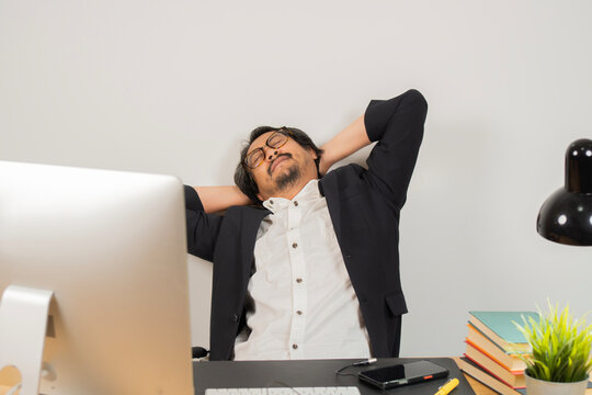Relaxed man take break from work put hands behind head lean on comfy chair closing eyes feels serenity - Powered by Adobe