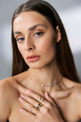 Stunning young woman radiating summer beauty with elegant jewelry and a serene expression