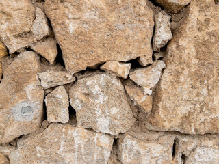 Weathered stone wall texture with cracked cement details