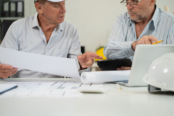 Obraz premium Engineering Team Collaborates on Blueprint Model in Corporate Office.