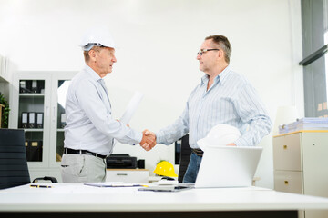 Fototapeta premium Construction engineers discussing plans with blueprints and digital tablet. Safety, teamwork, planning, and architecture