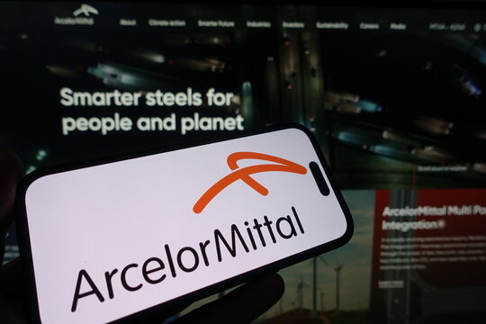 Kiel, Germany - 05-15-2025: Person holding smartphone with ArcelorMittal logo on screen in front of the companys website Focus on the phone display Unmodified photo