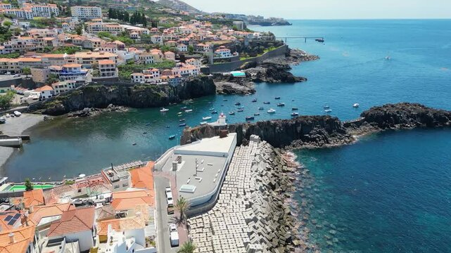 Concrete breakwater and lighthouse in Camara de Lobos on Madeira Island, Portugal