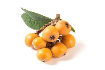 Ripe perfect loquats fruits with green leaves isolated on white background.