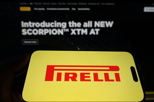 Kiel, Germany - 05-15-2025: Person holding smartphone with Pirelli logo on screen in front of the companys website Focus on the phone display Unmodified photo