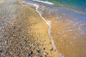 Close-up view of the sand and sea at Spiaggia di Piscinas beach, Sardinia, Italy