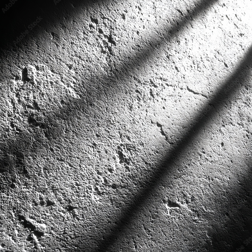Aufkleber Abstract Wall with Sunlight Stripes: A monochromatic textured surface with linear shadows creating a dramatic and minimalist scene.