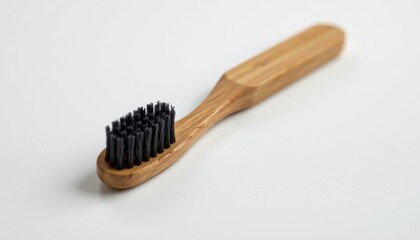 bamboo toothbrush with charcoal bristles, angled to highlight the smooth ergonomic handle and matte finish bristle head