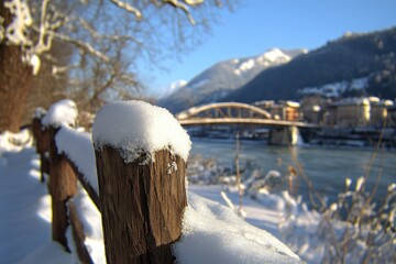 Snowy winter scene with a bridge and mountains