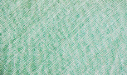 Light green woven surface closeup. Linen texture. Fabric background. Textured braided wallpaper.