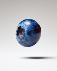 Single Blueberry Floating in Studio Still Life Shot Overhead View Close Up Detail Fresh Fruit Healthy Food