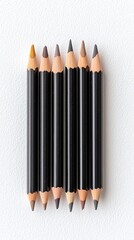 Seven Colored Pencils Arranged on White Background