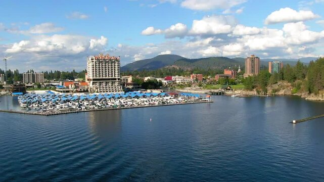 Aerial Panning Scenic View Of The Coeur D'Alene Resort In Town By Mountains, Drone Flying Over Lake - Coeur d`Alene, Idaho