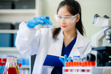 Discover a dedicated scientist conducting laboratory research, using pipettes, microscopes, and lab...