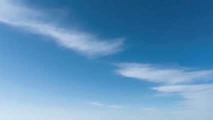 Obraz premium Vast blue sky with scattered clouds, a serene minimalist canvas of endless calm