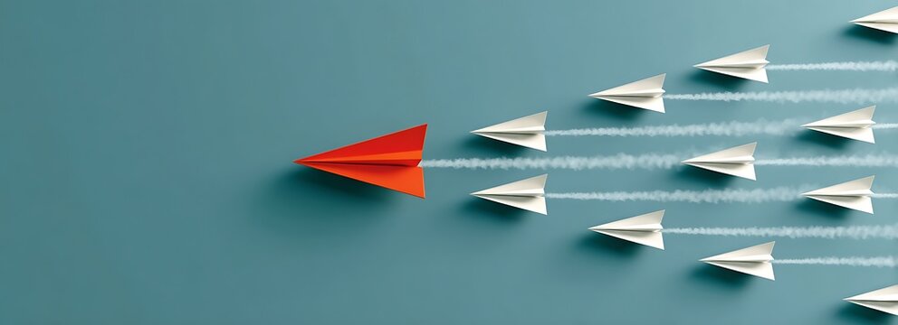 A red paper airplane leads a formation of white planes symbolizing leadership innovation strategy and success in business aviation and teamwork.