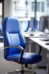 Blue leather office chair at empty desk in modern corporate workspace interior, eye level view, bright day