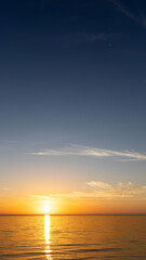 Fototapeta premium Sunrise over the sea with gentle waves and fading stars in a peaceful, dreamy atmosphere